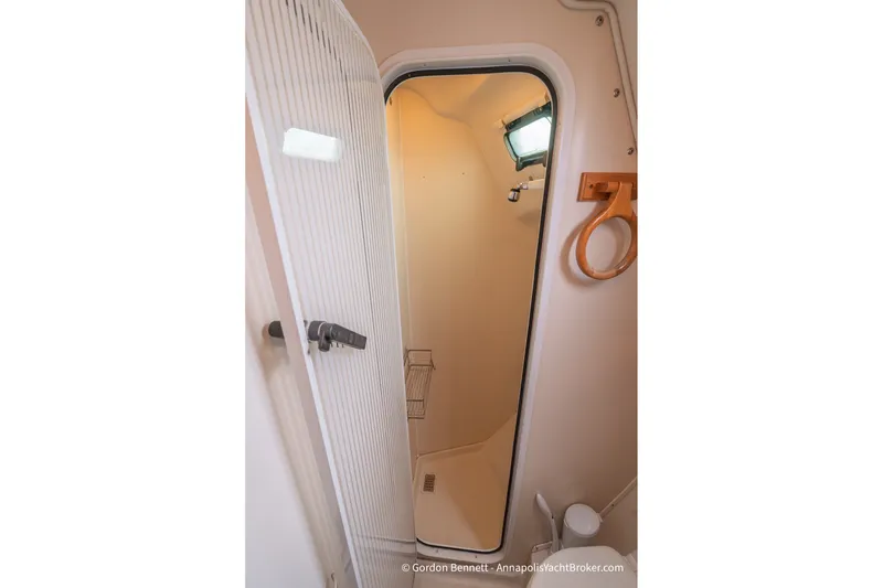Slide: The Image of Interior shower area of a 2003 Catalina 380 yacht, featuring a compact design. - 51