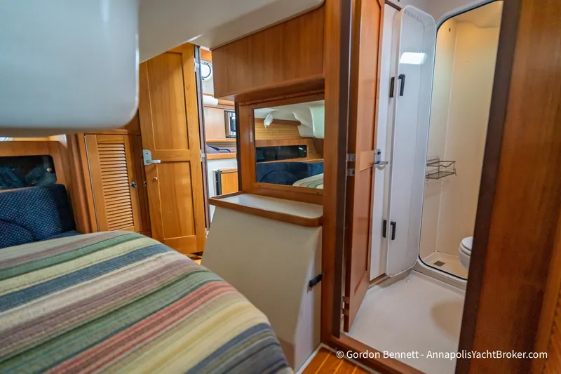Slide: The Image of Interior of 2003 Catalina 380 yacht featuring cozy cabin and compact bathroom. - 48