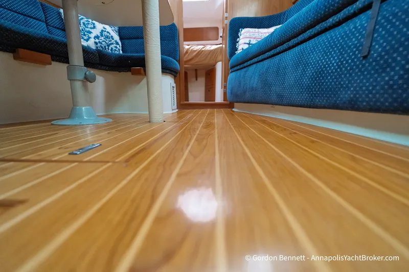Slide: The Image of Interior of 2003 Catalina 380 yacht with polished wooden flooring and blue seating. - 55