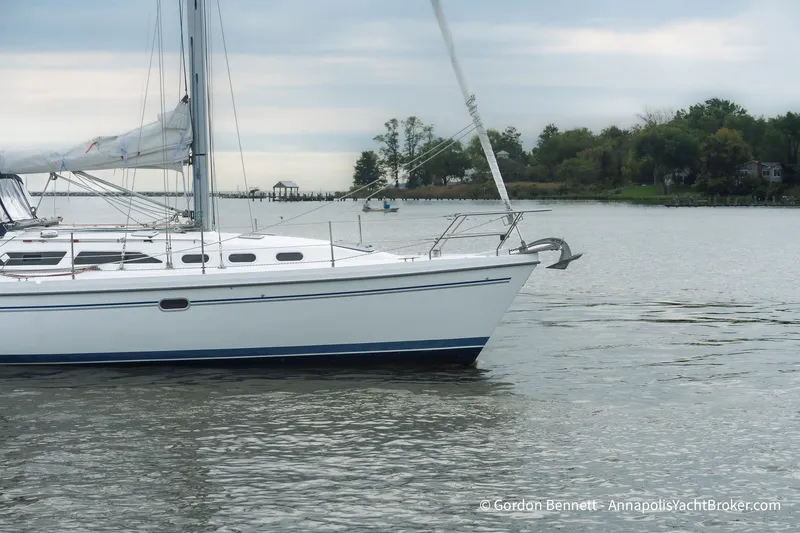 Slide: The Image of Sailboat on calm water, 2003 Catalina 380, overcast sky, shoreline in background. - 10