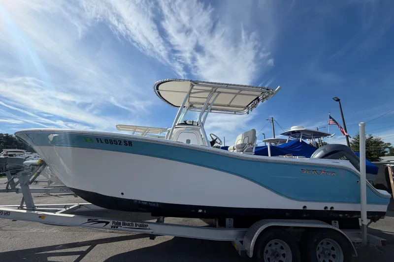 Slide: The Image of 2020 Sea Fox 228 Commander boat on trailer under clear blue sky. - 1