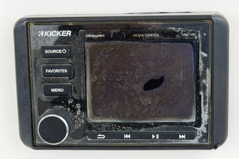 Slide: The Image of Kicker media center KMC100 on 2020 Sea Fox 228 Commander boat, showing weathered controls. - 28