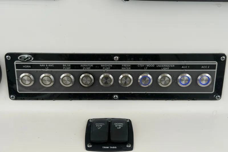 Slide: The Image of Control panel of a 2020 Sea Fox 228 Commander boat with various switches. - 27