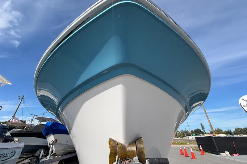 Slide: The Image of 2020 Sea Fox 228 Commander boat with blue hull, viewed from the front. - 7