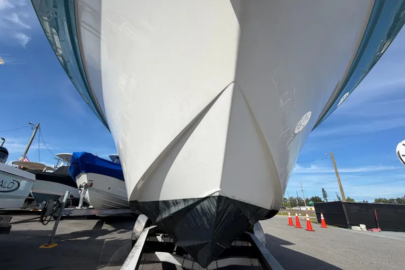 Slide: The Image of 2020 Sea Fox 228 Commander boat on trailer, viewed from below, with clear blue sky. - 8