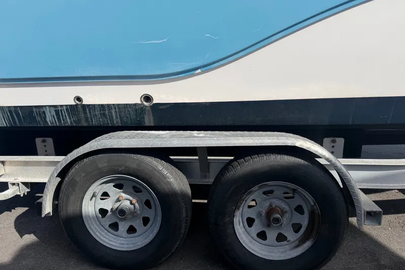 Slide: The Image of Trailer with Sea Fox 228 Commander boat, 2020 model, parked on pavement. - 20