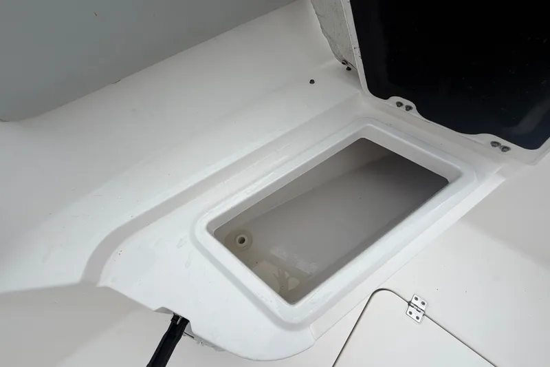 Slide: The Image of 2020 Sea Fox 228 Commander storage compartment, open and empty, showcasing interior space. - 44