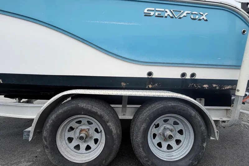 Slide: The Image of 2020 Sea Fox 228 Commander boat on trailer, showcasing blue and white hull design. - 78