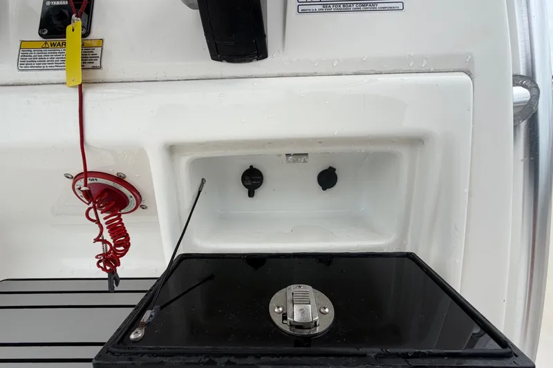 Slide: The Image of The image shows part of the cockpit of a Sea Fox 228 Commander boat with control elements. - 31