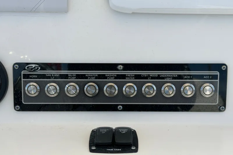 Slide: The Image of Control panel of a 2020 Sea Fox 228 Commander boat with labeled switches. - 12