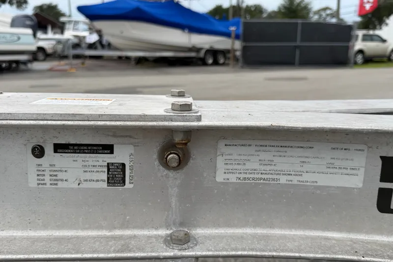 Slide: The Image of Trailer information labels on a 2020 Sea Fox 228 Commander, parked with other boats. - 77