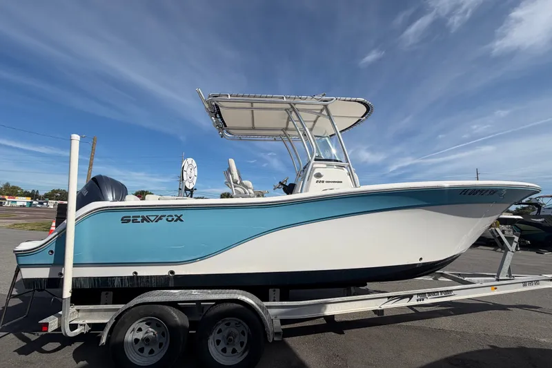 Slide: The Image of 2020 Sea Fox 228 Commander boat on trailer under clear blue sky. - 5