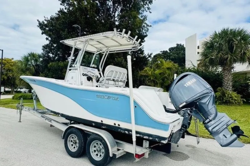 Slide: The Image of 2020 Sea Fox 228 Commander boat on trailer with Yamaha outboard motor, parked outdoors. - 1