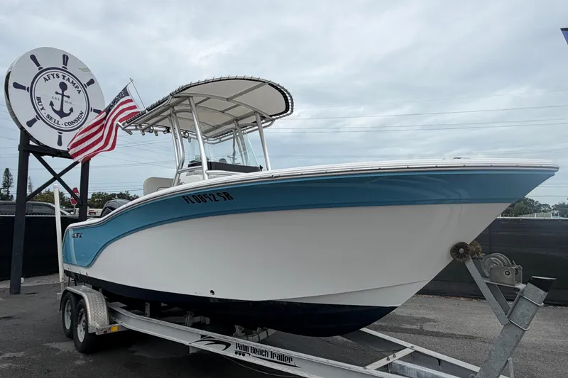 The Image of 2020 Sea Fox 228 Commander boat on trailer with American flag, displayed at dealership. - 0