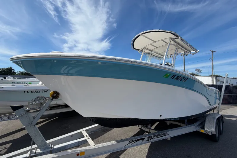 The Image of 2020 Sea Fox 228 Commander boat on trailer under clear blue sky. - 0