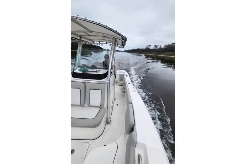 Slide: The Image of 2020 Sea Fox 228 Commander cruising on calm waters, showcasing sleek design and spacious seating. - 6