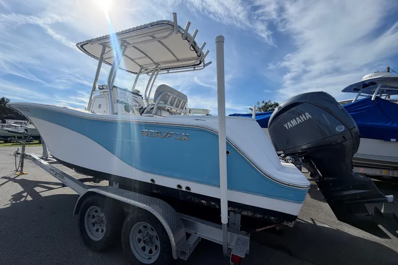 Slide: The Image of 2020 Sea Fox 228 Commander boat on trailer with Yamaha engine under sunny sky. - 2