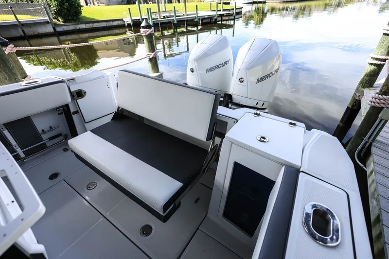 Slide: The Image of 2019 Blackfin 272 CC boat with Mercury engines, docked by a calm waterfront. - 6