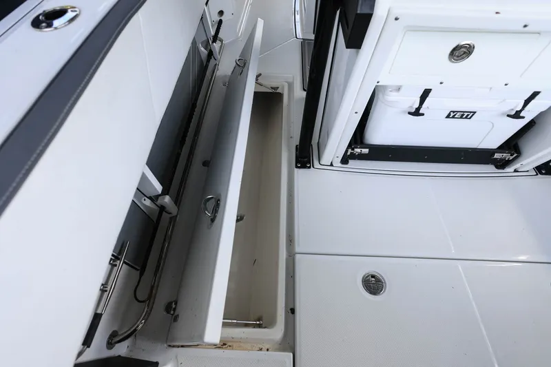 Slide: The Image of 2019 Blackfin 272 CC boat interior with storage compartments and Yeti cooler. - 20
