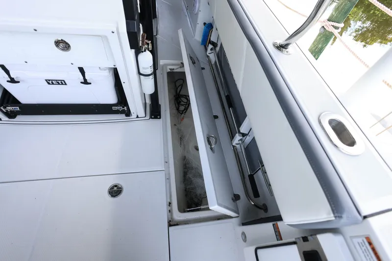 Slide: The Image of 2019 Blackfin 272 CC boat interior with storage compartments and Yeti cooler. - 21