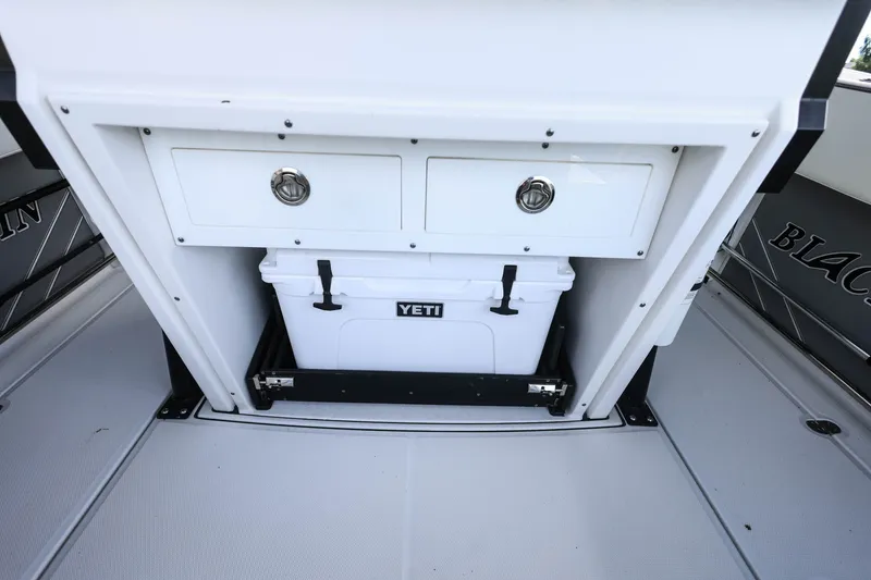 Slide: The Image of 2019 Blackfin 272 CC boat interior with Yeti cooler and storage drawers. - 8