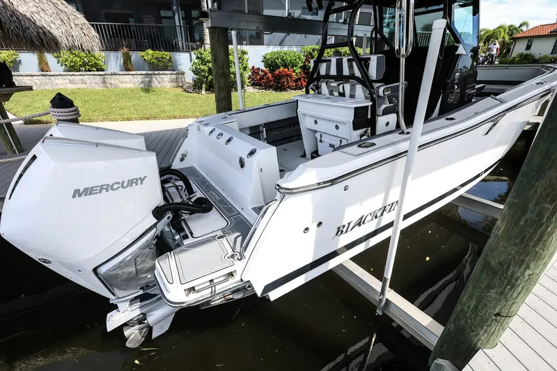 Slide: The Image of 2019 Blackfin 272 CC boat with Mercury engine docked at marina. - 2