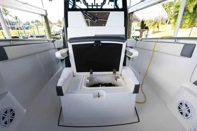 Slide: The Image of 2019 Blackfin 272 CC boat interior with open storage compartment and seating. - 16