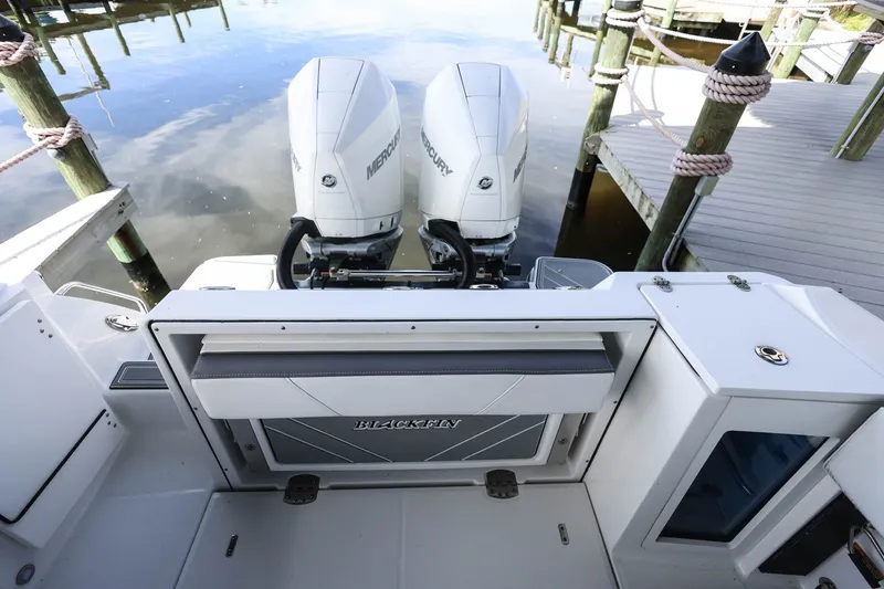 Slide: The Image of 2019 Blackfin 272 CC boat with dual Mercury engines docked at a marina. - 5