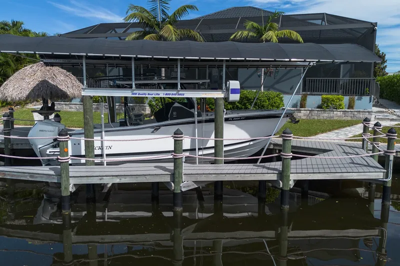 The Image of 2019 Blackfin 272 CC boat docked with Mercury engines, surrounded by tropical scenery. - 0