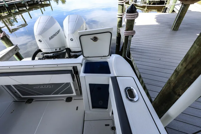 Slide: The Image of 2019 Blackfin 272 CC boat with Mercury engines docked by wooden pier. - 7