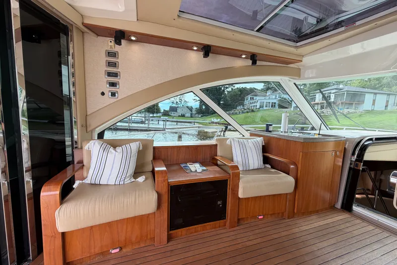 Slide: The Image of Luxurious interior of 2006 Sea Ray 60 Sundancer yacht with plush seating and scenic view. - 44