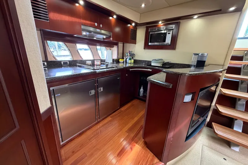 Slide: The Image of Luxurious 2006 Sea Ray 60 Sundancer yacht kitchen with modern appliances and wood finishes. - 31