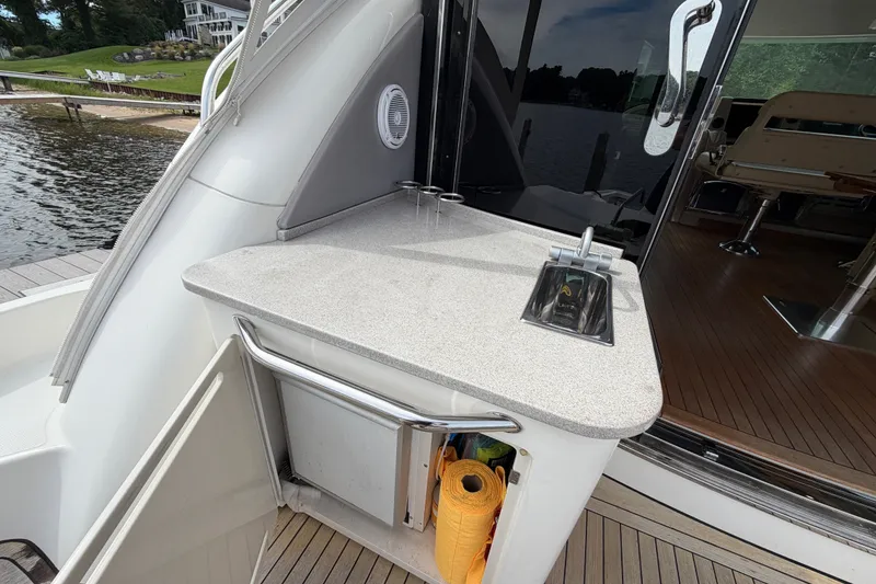 Slide: The Image of 2006 Sea Ray 60 Sundancer yacht with outdoor sink and countertop by the water. - 41