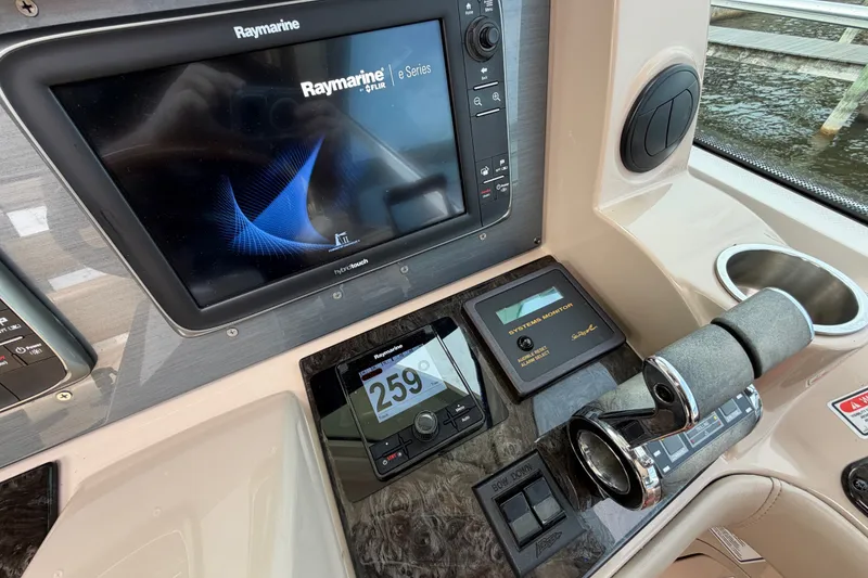 Slide: The Image of Helm of 2006 Sea Ray 60 Sundancer with Raymarine navigation system and controls. - 32