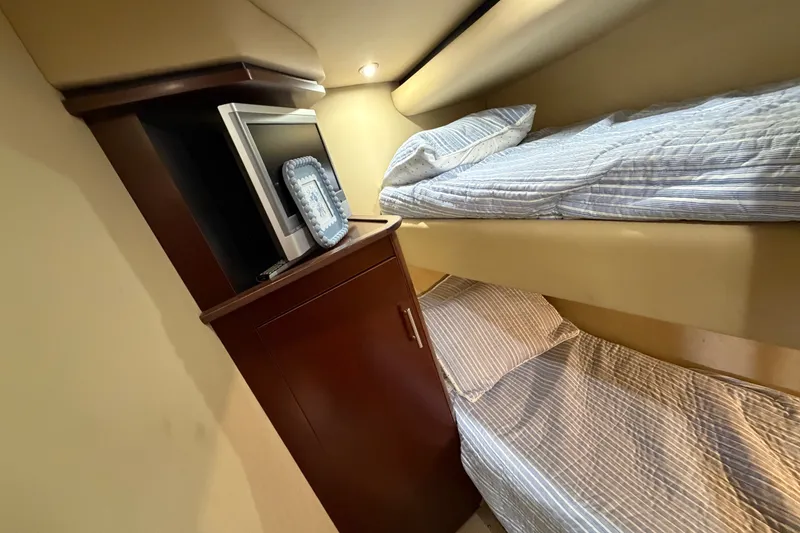 Slide: The Image of Interior of 2006 Sea Ray 60 Sundancer with bunk beds and TV cabinet. - 14
