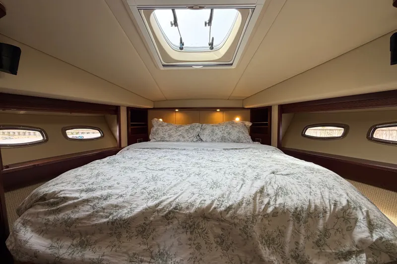 Slide: The Image of Luxurious 2006 Sea Ray 60 Sundancer yacht bedroom with skylight and elegant bedding. - 23