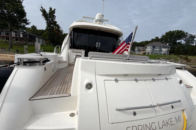 Slide: The Image of 2006 Sea Ray 60 Sundancer yacht docked, displaying American flag, Spring Lake, MI. - 46