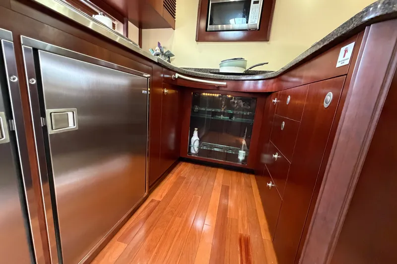 Slide: The Image of Luxurious kitchen interior of 2006 Sea Ray 60 Sundancer yacht with wood cabinetry. - 33