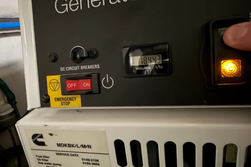 Slide: The Image of Control panel of a 2006 Sea Ray 60 Sundancer generator, showing 1844.3 hours. - 13