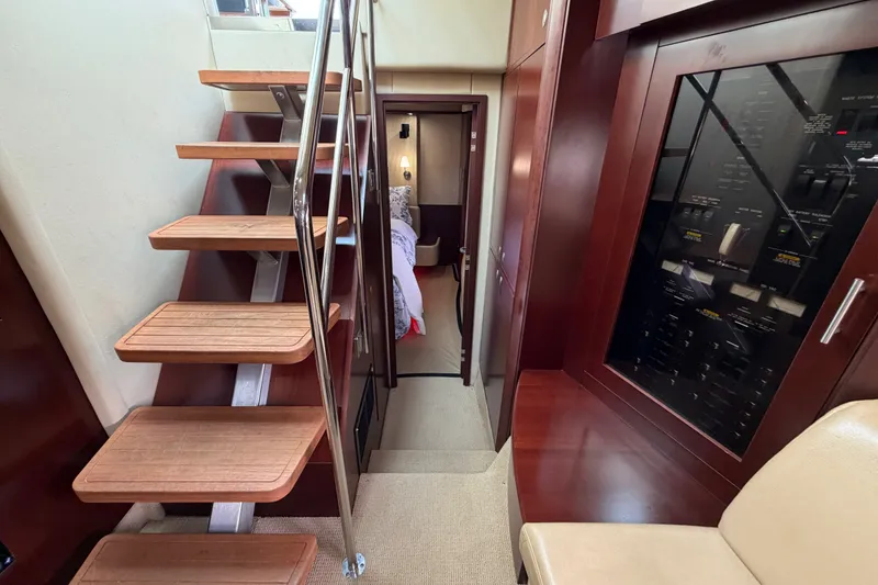 Slide: The Image of Interior of 2006 Sea Ray 60 Sundancer yacht with wooden stairs and control panel. - 35