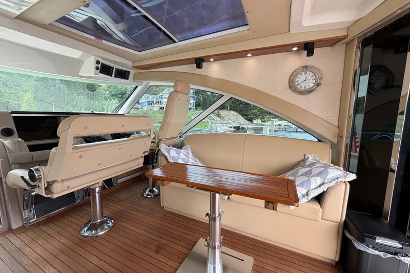 Slide: The Image of Luxurious interior of 2006 Sea Ray 60 Sundancer yacht with plush seating and wooden table. - 40