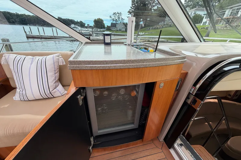Slide: The Image of Luxurious 2006 Sea Ray 60 Sundancer yacht interior with kitchenette and scenic water view. - 39