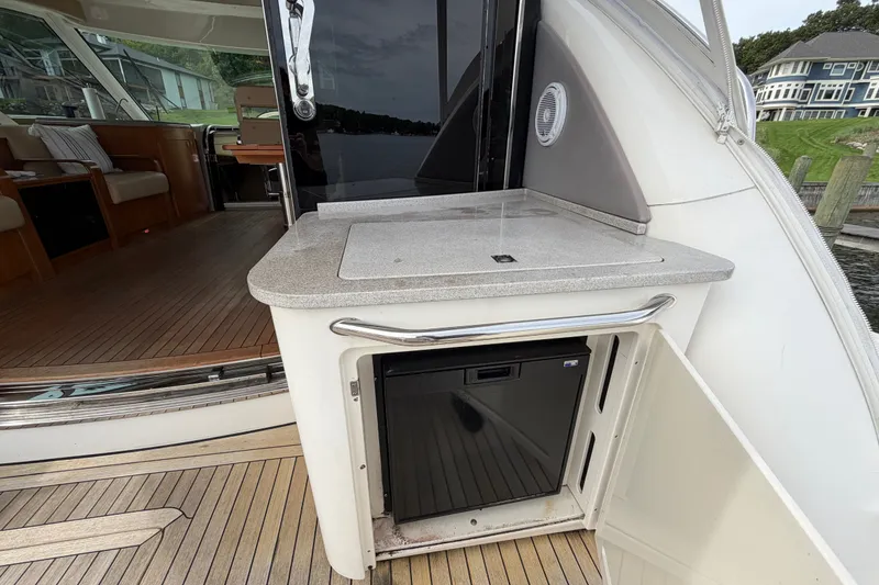 Slide: The Image of 2006 Sea Ray 60 Sundancer yacht interior with kitchenette and seating area. - 45