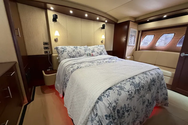 Slide: The Image of Luxurious 2006 Sea Ray 60 Sundancer yacht bedroom with elegant bedding and ambient lighting. - 22