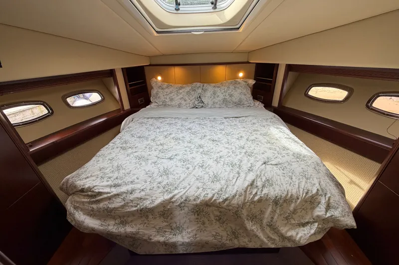 Slide: The Image of Luxurious bedroom interior of 2006 Sea Ray 60 Sundancer yacht with skylight and elegant bedding. - 24