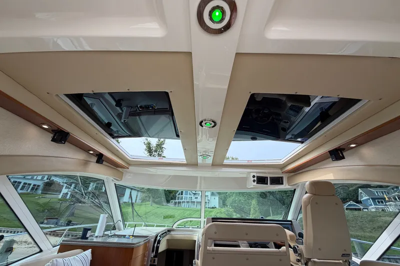 Slide: The Image of Interior view of 2006 Sea Ray 60 Sundancer yacht with sunroof and modern controls. - 47