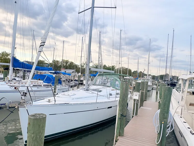 The Image of A 2005 Beneteau Oceanis Clipper 343 docked at a wooden pier in a marina. - 0