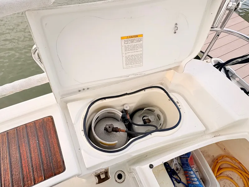 Slide: The Image of An open storage compartment on a 2005 Beneteau Oceanis Clipper 343 reveals gas cylinders. - 19
