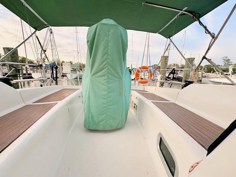 Slide: The Image of The image shows the cockpit of a Beneteau Oceanis Clipper 343 with green cover and wooden benches. - 42