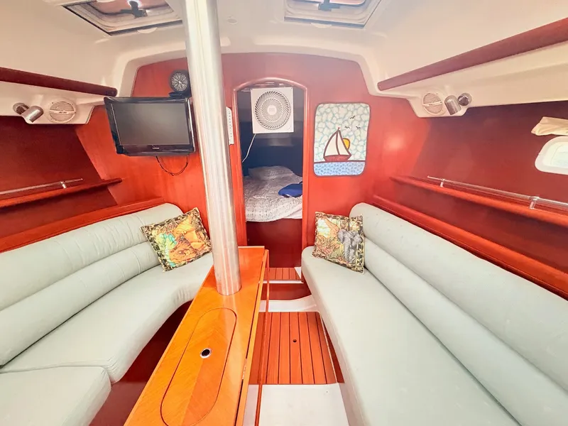 Slide: The Image of Interior of a 2005 Beneteau Oceanis Clipper 343 with cozy seating and a sleeping area. - 25